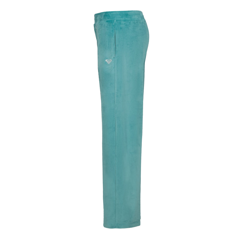 Side view of Roxy Girls’ Velour Pant in teal, featuring a relaxed fit, an elastic waistband, and a small logo on the hip.