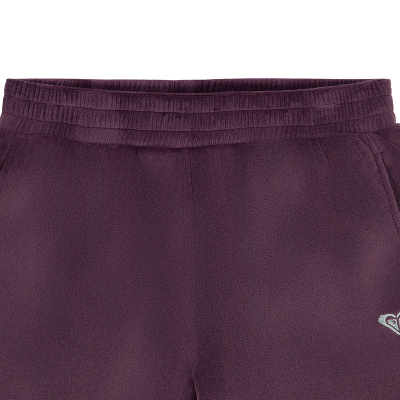 Close-up of Roxy Girls’ Velour Pant in plum, featuring a relaxed fit, elastic waistband, and a small logo on the hip.