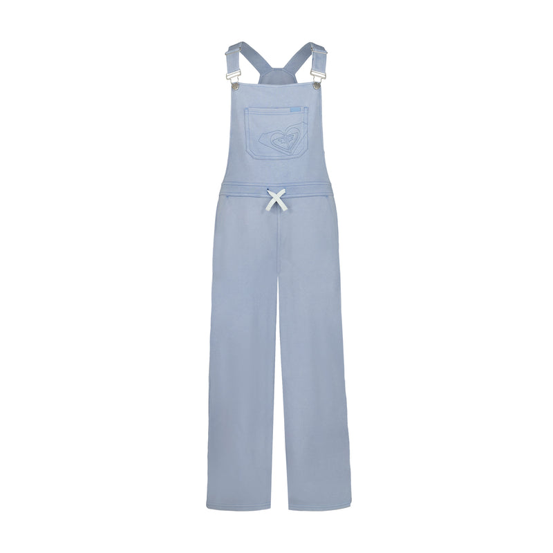 The Girls' Coastline Overall by Roxy features light blue, soft cotton-poly French terry, adjustable straps, a front chest pocket with stitched heart, a white waist bow, and straight full-length legs.