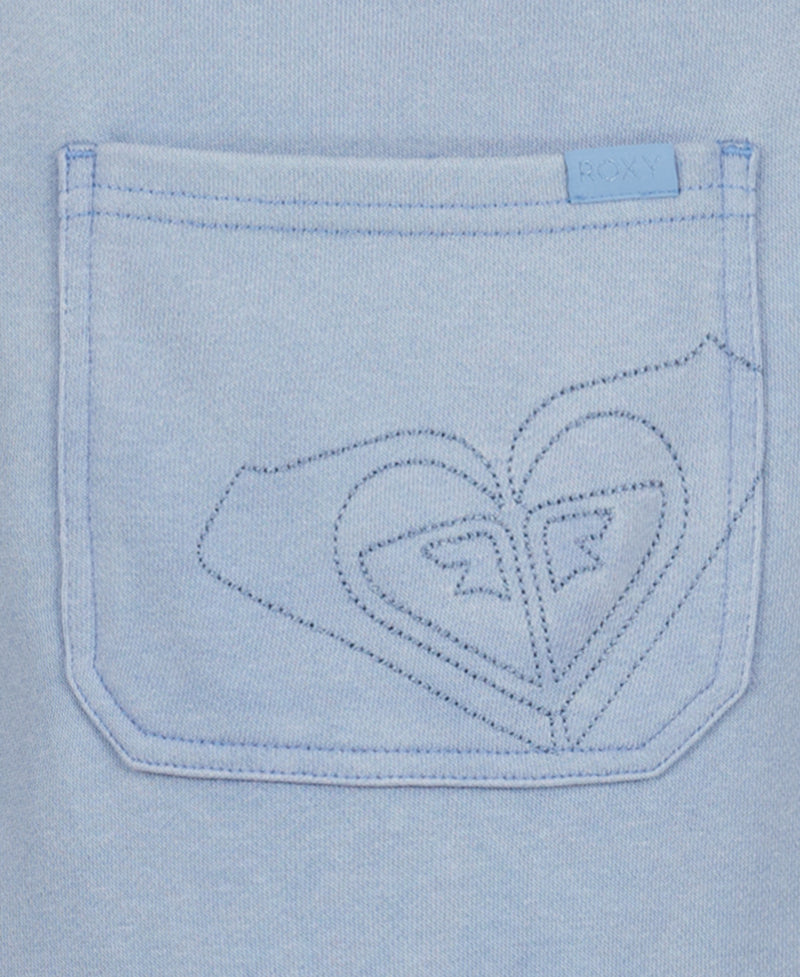 A close-up of a light blue cotton-poly French terry pocket with decorative heart-shaped stitching and a Roxy tag, perfect for pairing with the Girls' Coastline Overall by Roxy.
