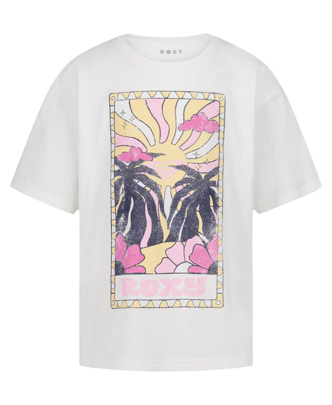 The Girls' Sun-Kissed Oversized Tee by Roxy features a vibrant front graphic of palm trees, pink clouds, a yellow sunburst, and flowers. Made from soft cotton jersey, it has "ROXY" in pastel colors at the bottom.