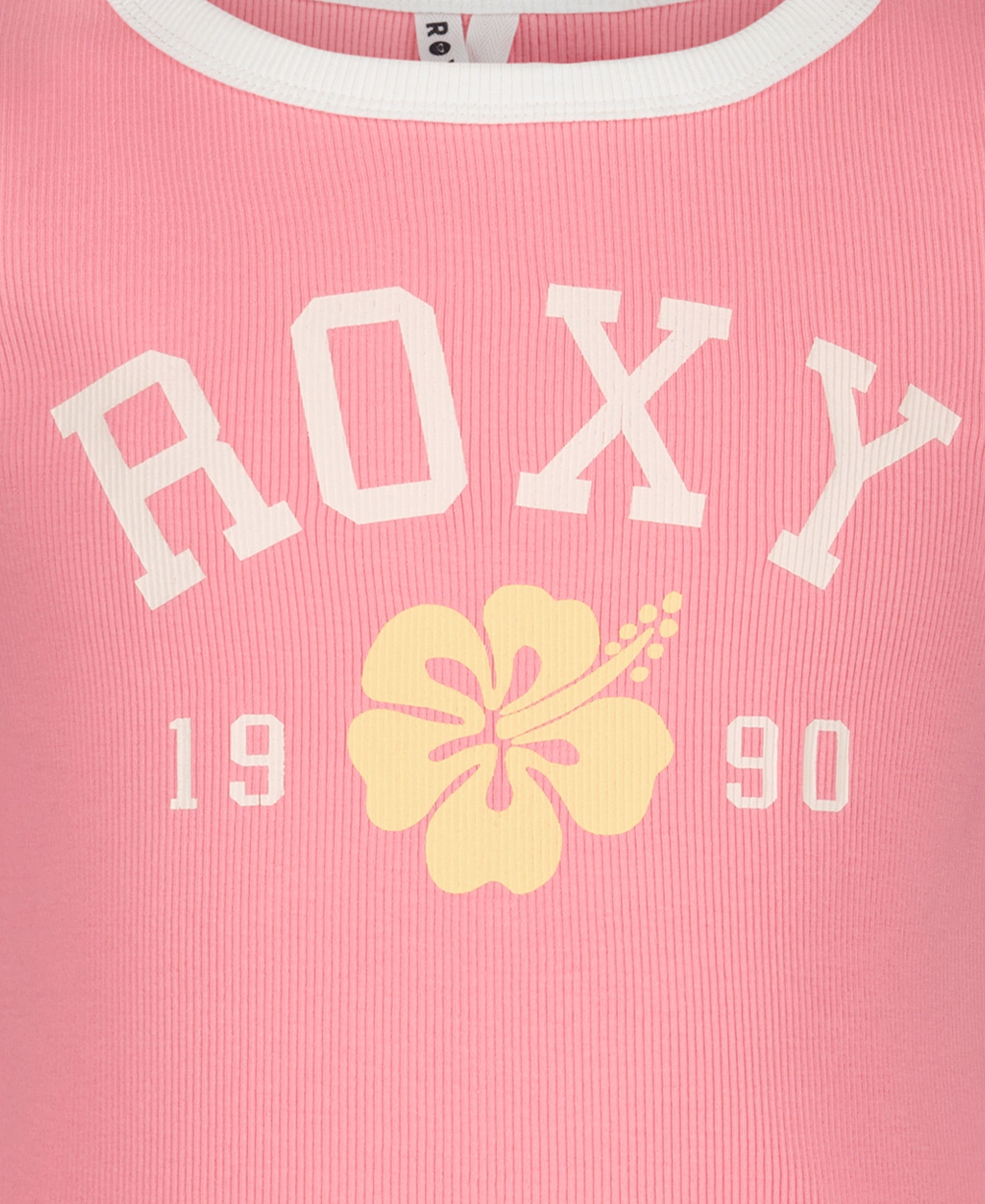 Close-up of the Girls' Collegiate Arch Tank by Roxy in pink ribbed fabric, showing white ROXY text, a yellow hibiscus flower, "1990" print, girls’ fitted tank style, and a white collar detail for vintage flair.