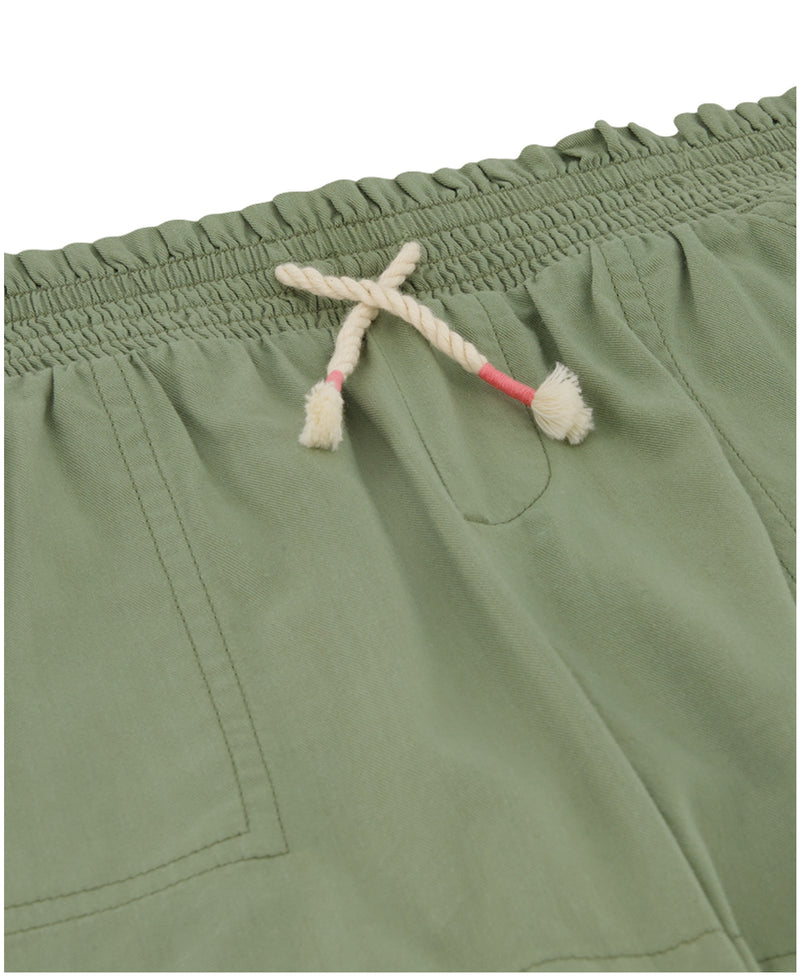 Close-up of Roxy Girls' Soleil Short in light green brushed twill, featuring a smocked elastic waistband, off-white drawstring with pink accents, and visible front pockets.