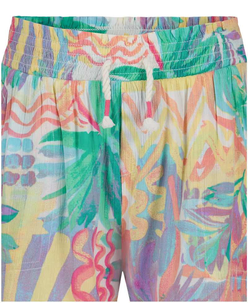 Close-up of Roxy Girls' Palm Sun Soleil Short, featuring an abstract palm print in green, pink, yellow, and blue with a smocked elastic waistband and white drawstring for comfort and style.
