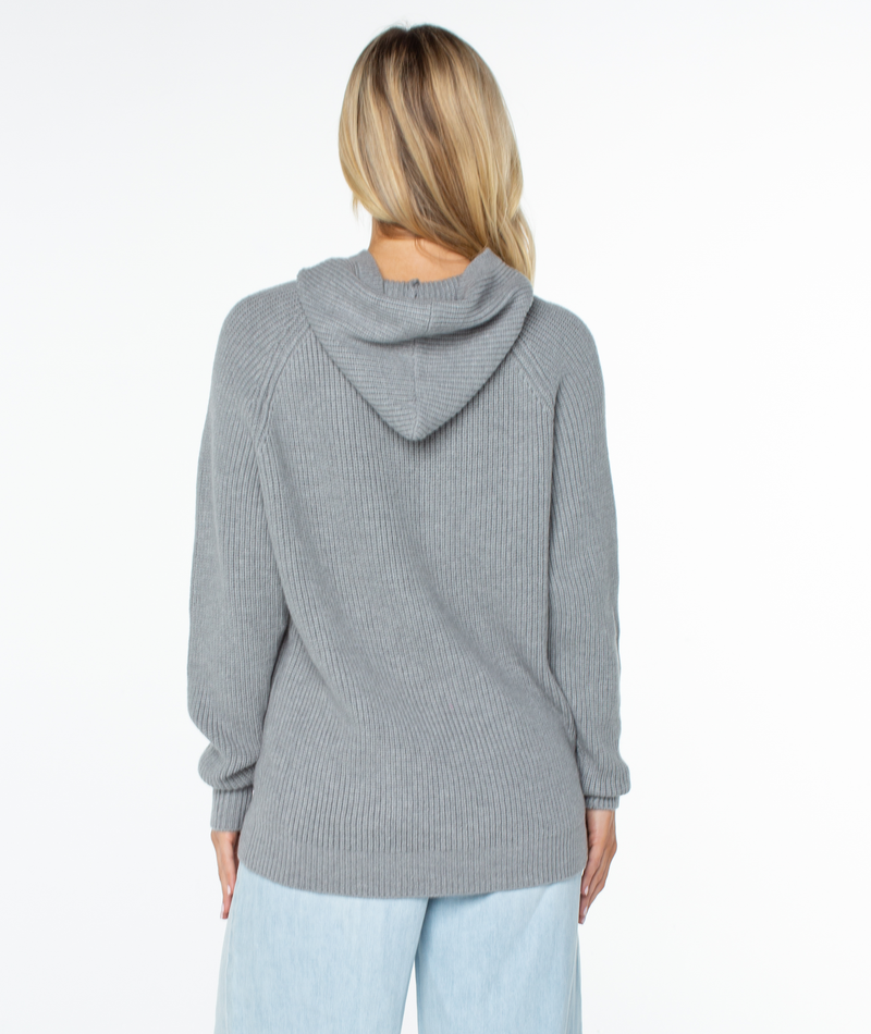 Back view of a person wearing a grey ribbed knit Roxy Cozy Town Sweater hoodie.