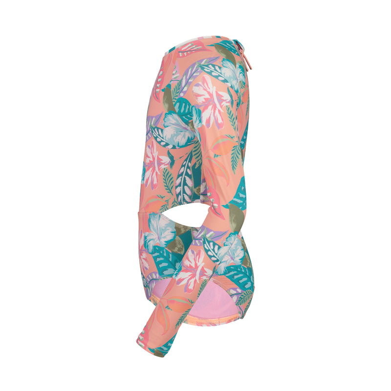 Side view of the Roxy Girls' Hot Tropics Onesie, a one-piece swimsuit with long sleeves and a pink, green, and white tropical print. Features a midriff cutout for a trendy look.