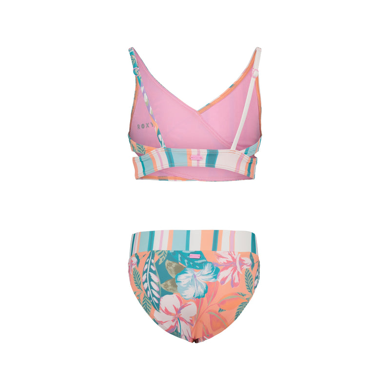 The Roxy Girls' Hot Tropics Bikini Set is a two-piece swimsuit with medium coverage, featuring a pink crossover strap top with stripes and matching bottoms in striped and tropical floral prints in pink, teal, and orange.