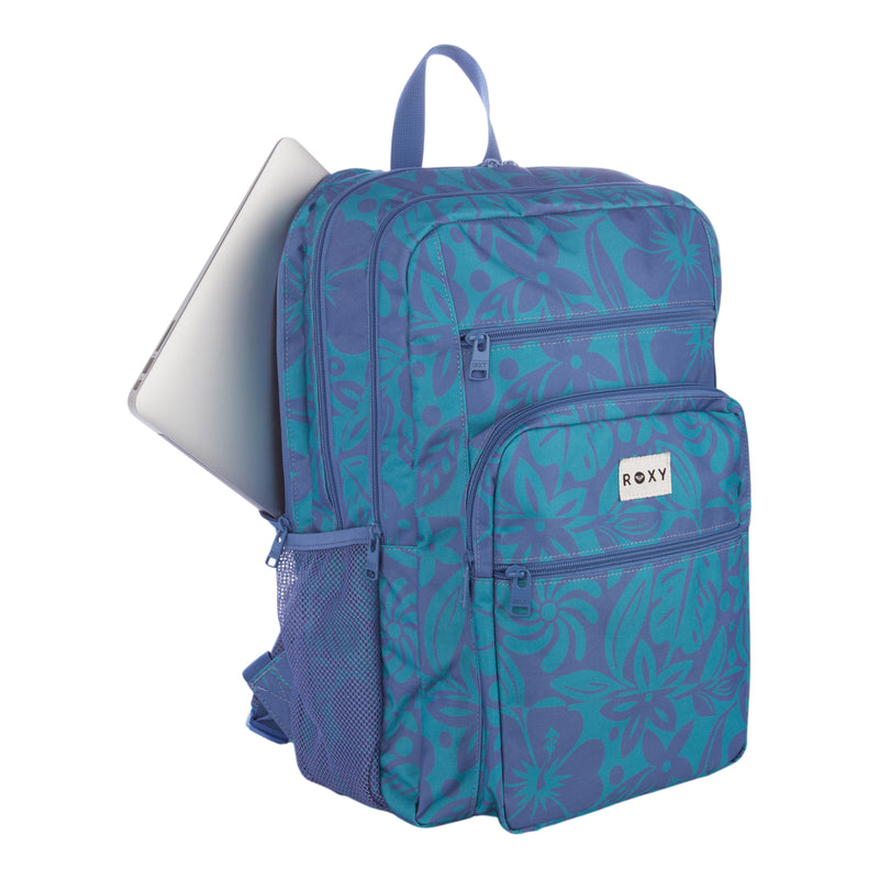 A blue and purple floral Roxy Campus Crush Backpack made from recycled polyester, featuring multiple zippers, a mesh side pocket, a padded laptop sleeve, and a laptop partially tucked into the main compartment.