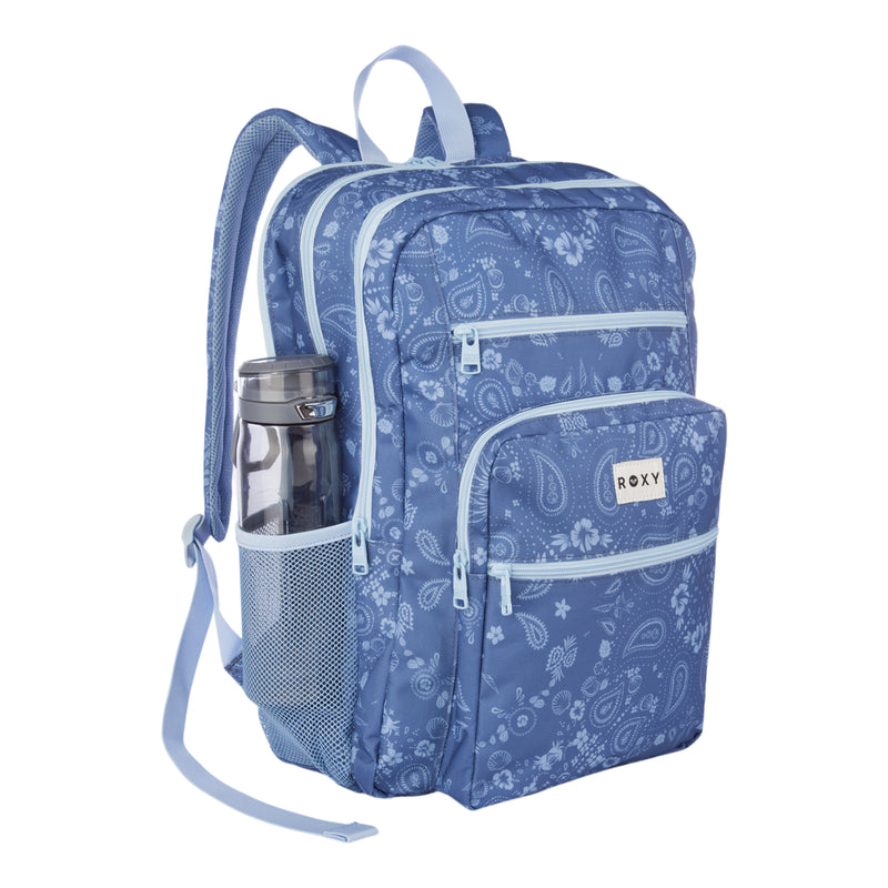 The Roxy Campus Crush Backpack in blue showcases a paisley pattern and is made from recycled polyester. It offers multiple zippered compartments, a padded laptop sleeve, organizer pockets for convenience, and a mesh side pocket that holds a water bottle. The Roxy logo appears on the front pocket.