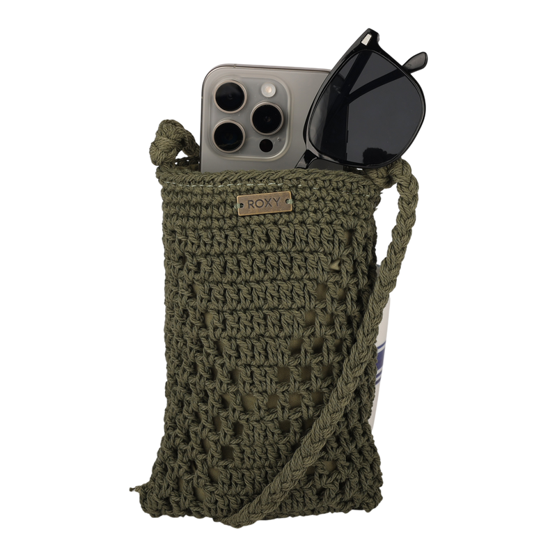 The Chips And Guac Phone Bag by Roxy is a green crocheted crossbody pouch with a strap, designed to hold a smartphone and a pair of black sunglasses, and features a small metal Roxy label on the stylish bag.