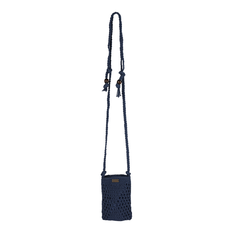 A small, dark blue, crocheted crossbody bag with a long strap and tassel accents. The bag has a rectangular shape and a small ROXY logo label on the front, making it the perfect stylish bag for casual outings.