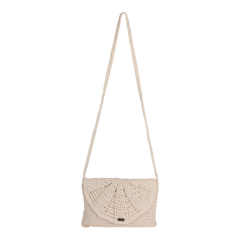 The Roxy Chips And Guac Medium Crossbody Bag in Egret features a beige crochet design with a long braided strap and a flap closure adorned with a sunburst pattern, making it the perfect hands-free everyday essential, shown against a plain white background.