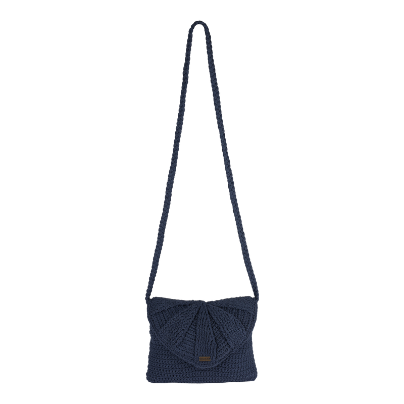 The Roxy Chips And Guac Medium Crossbody Bag, featuring a navy blue crocheted design with a long strap and a flap closure for hands-free convenience, is showcased against a plain white background.