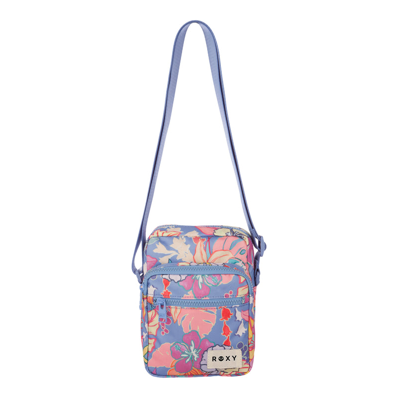 The ROXY Current Mood Crossbody Bag is a small, rectangular floral bag with a blue adjustable strap, decorated with pink, purple, and orange flowers. It features a front zippered pocket and a white ROXY label on the front.