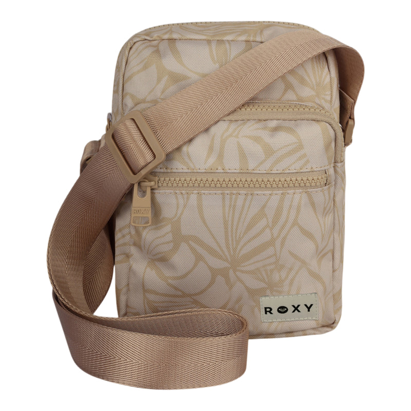 The Current Mood Crossbody Bag by ROXY is a small beige bag with a light leaf pattern, an adjustable strap, a front zipper pocket, and a ROXY logo patch at the bottom right corner.