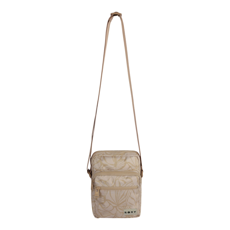 The Current Mood Crossbody Bag by ROXY showcases a subtle leaf pattern in beige, two zippered compartments, and an adjustable strap for a customized fit. A small green ROXY label accents the front lower right corner of the bag.