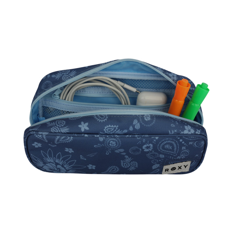 A blue floral-patterned Smarty Pack Supplies Organizer by ROXY, crafted from recycled polyester, serves as a stylish pouch for supplies, holding an Apple charger and two markers—one orange and one green—with its zipper open to display the neatly organized school essentials inside.