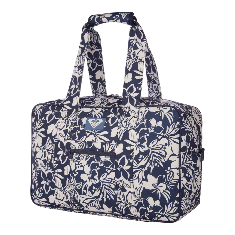 The Roxy Off Shore Duffel Bag is a rectangular duffel featuring navy blue and white floral patterns, two handles, a front zipper pocket, and a small logo on the front—making it the perfect go-to travel bag.