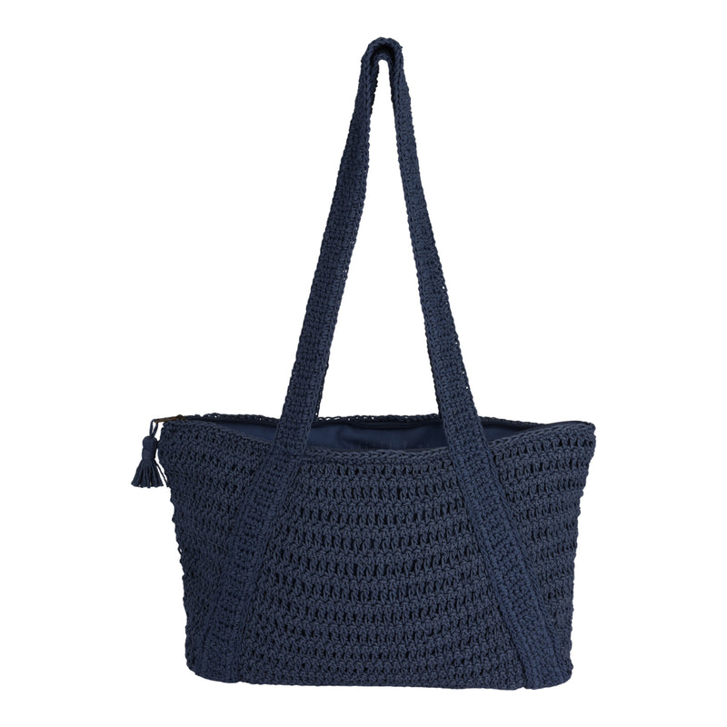 The Roxy Chips And Guac Tote Bag is a spacious, navy blue woven tote featuring long shoulder straps and a small tassel accent on the side, complete with a zippered top for added security—an ideal travel companion, displayed against a plain white background.