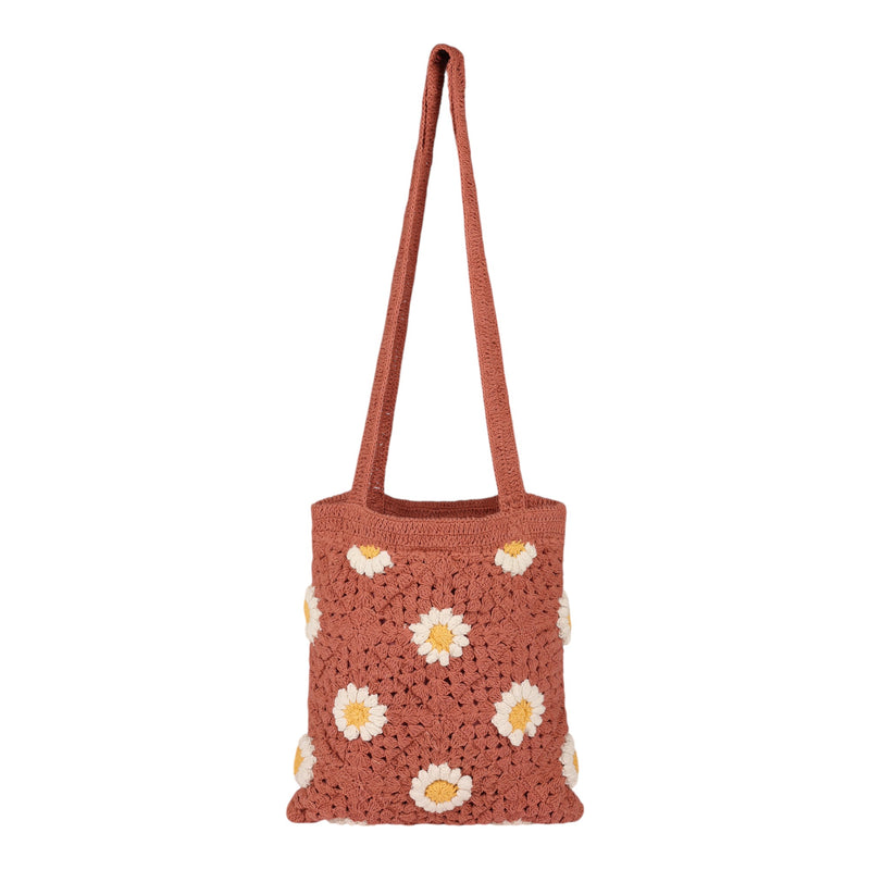 Introducing the Wandering Beach Crochet Tote Bag by Roxy—a brownish-pink casual tote featuring a long strap and beautifully decorated with white and yellow daisy patterns on the front, making it the perfect accessory for everyday outings or your next beach day.