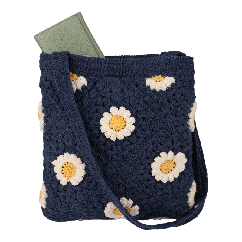 The Wandering Beach Crochet Tote Bag by Roxy is a navy blue tote adorned with white and yellow daisy patterns. This lightweight bag features a green embossed notebook partially visible at the top.
