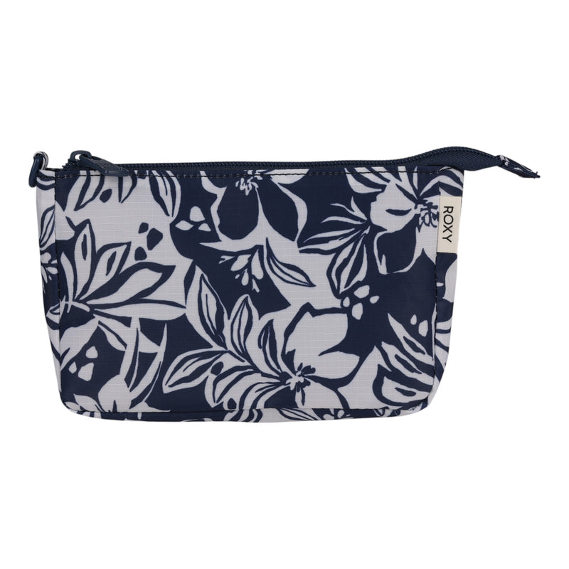 A compact zippered pouch from the Roxy Travel Pouch Set, designed with a navy blue and white floral pattern and a fabric side tag displaying the Roxy brand—ideal for travel organization and packing essentials.