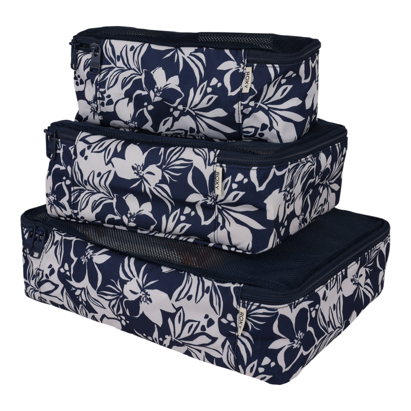 A set of three Roxy Packing Cubes, featuring a navy blue design with white floral patterns, are stacked together. Made from lightweight ripstop material, each cube includes a zipper closure and mesh top—ideal travel essentials for neatly organizing your clothing and other items on the go.