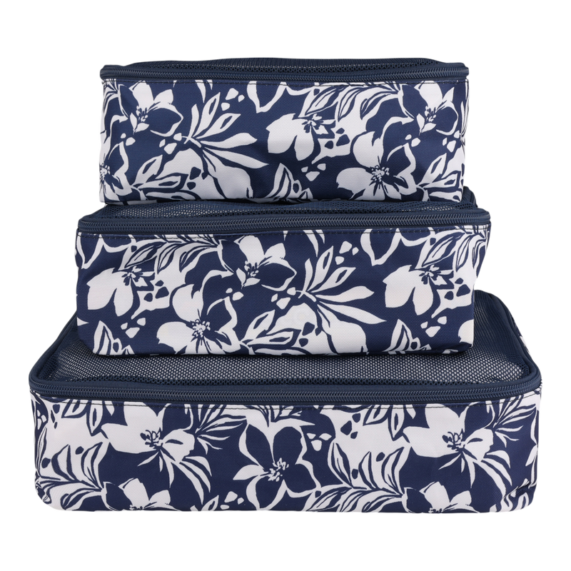 Three navy blue Roxy Packing Cube Set pieces, adorned with white floral patterns, are stacked atop one another against a plain white background. These lightweight ripstop organizers are must-have travel essentials, designed to keep your belongings neatly organized and protected on every trip.
