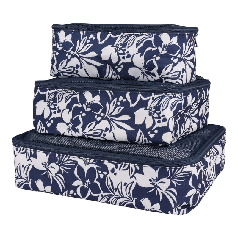 Three navy blue Roxy Packing Cube Set pieces featuring white floral patterns are stacked together in varying sizes—these travel essentials are crafted from lightweight ripstop material to keep your belongings organized and secure on the go.