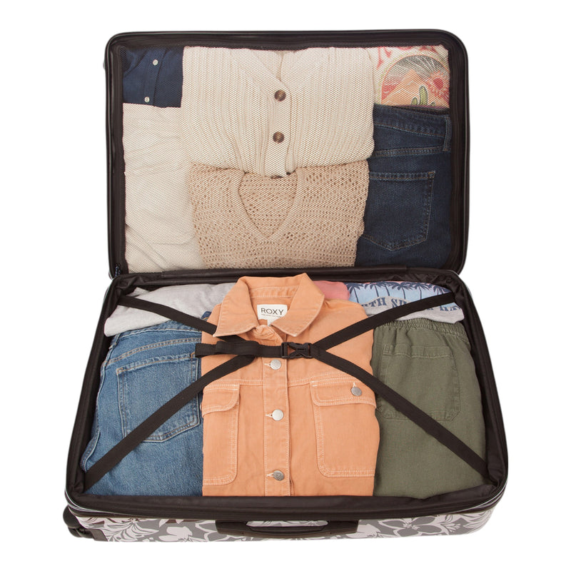 The Roxy Up And Away Hardside Spinner Large Luggage, featuring a durable PC/ABS shell, is shown open and neatly packed with folded sweaters, jeans, a peach jacket, and green pants, all secured with black straps.