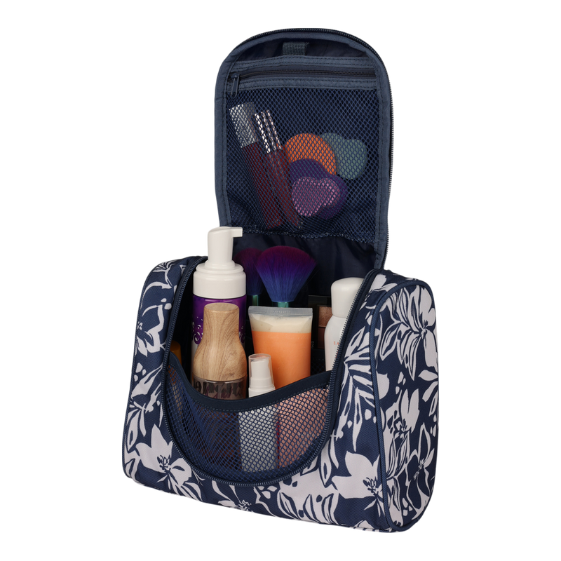 The Roxy Travel Dance Toiletry Kit in blue floral is shown open, revealing bottles, a pump dispenser, a makeup brush, toothbrushes, and small containers neatly organized in mesh pockets. Made from recycled polyester, this travel storage bag keeps your essentials tidy and easily accessible wherever your journey takes you.