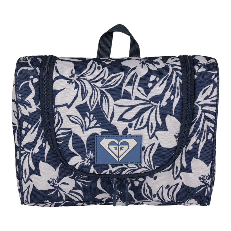 Introducing the Roxy Travel Dance Toiletry Kit in Oceanside—a navy and white floral-patterned hanging bag featuring a front logo patch, top handle, and zipper closure, thoughtfully crafted from recycled polyester for sustainable travel storage.