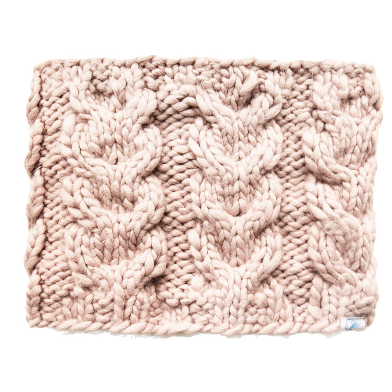 A chunky, light pink knitted fabric with a thick cable pattern, displayed flat on a white background—the perfect choice for crafting the Roxy Winter Collar, a cozy women’s scarf or chunky knit neck warmer designed to keep you warm and stylish all winter long.