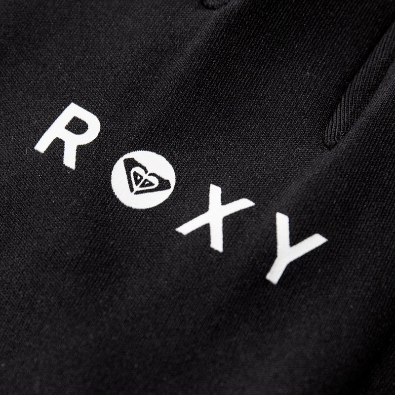 Close-up of black fabric with the word “ROXY” in white lettering, where the O is replaced by Roxy’s signature heart-shaped wave logo. Featured on the women’s Hydrosmart Liner Gloves by Roxy, these fleece gloves are touchscreen-compatible for added convenience.