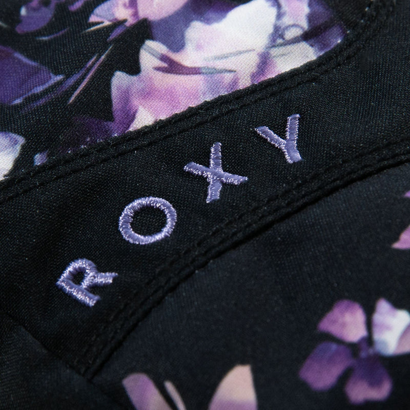 Close-up of black fabric featuring purple embroidered “ROXY” text and a floral pattern in shades of purple and white, as seen on the Roxy Girls Jetty Girl Gloves by Roxy.