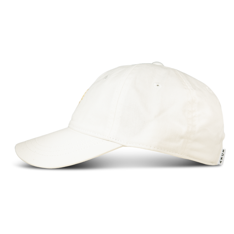 The Next Level Cap by Roxy is displayed in a side view against a white background. Made from soft cotton twill, this women’s baseball hat features a curved visor and visible stitching.
