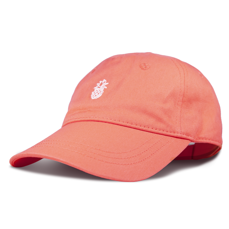 The Roxy Next Level Cap is a coral pink women’s baseball hat made from soft cotton twill, featuring a small white embroidered pineapple on the front and a classic curved visor, shown against a plain white background.