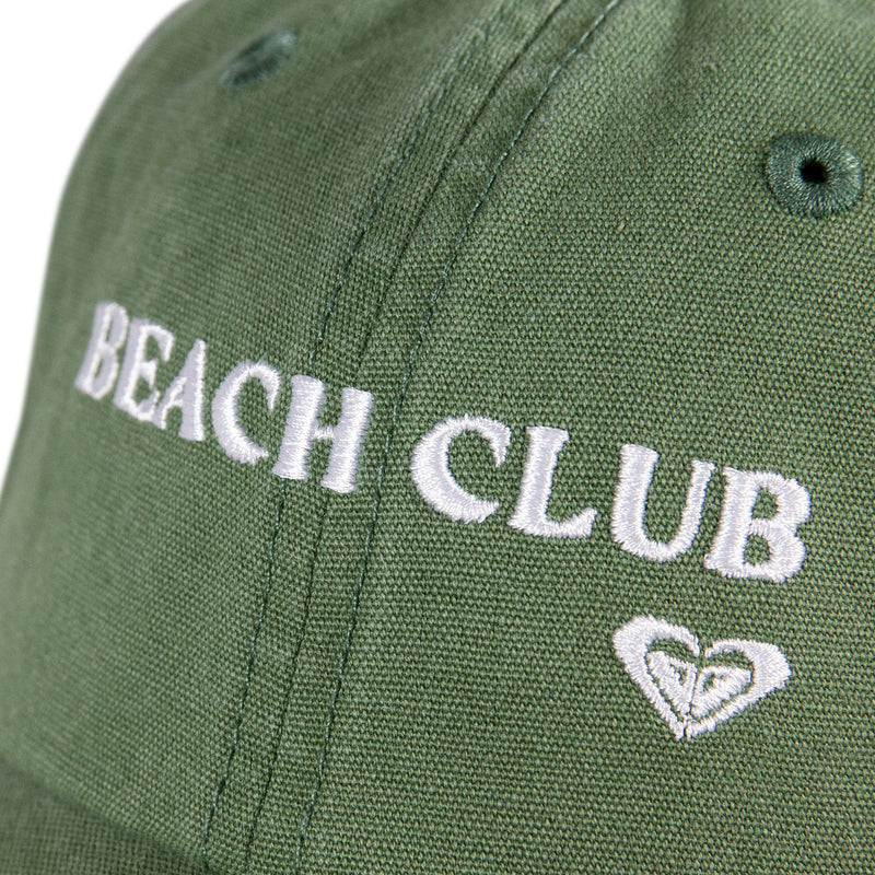 Close-up of a green Toadstool Cap by Roxy, featuring “BEACH CLUB” embroidered in white above a heart-shaped logo, highlighting the cool style typical of Roxy hats.