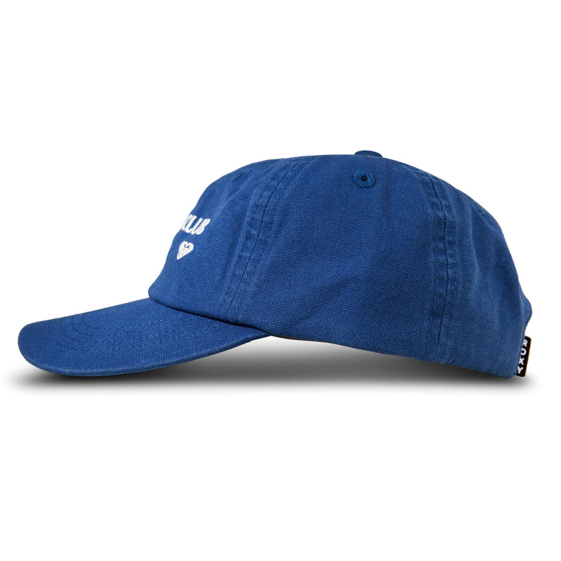 A side-view of the Roxy Toadstool Cap in blue, featuring white embroidered text and a small heart symbol on the front, plus a black and white tag on the back—ideal for those who love sleek, stylish baseball hats.
