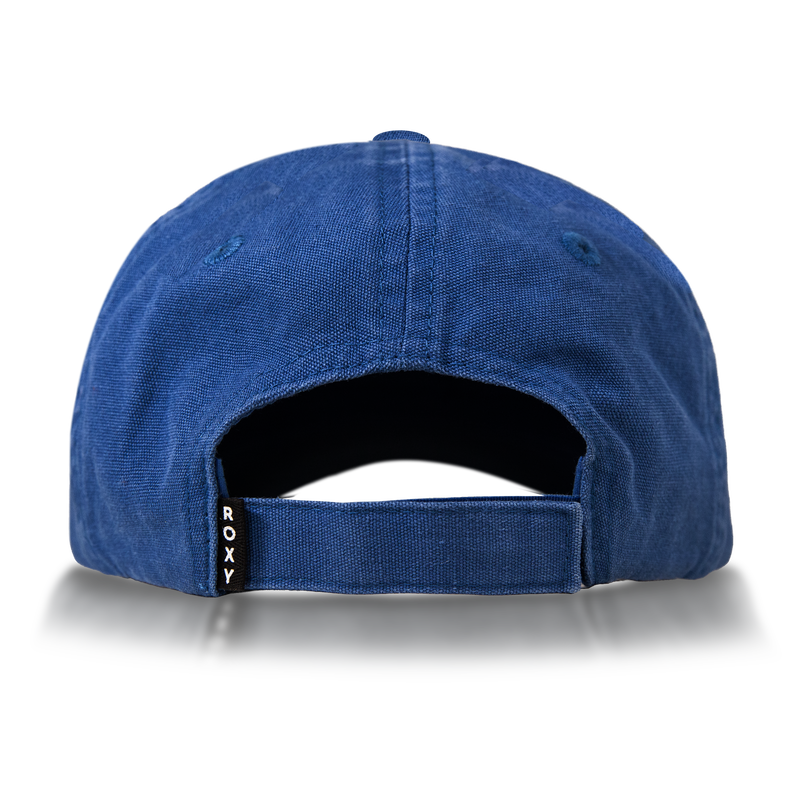 A blue Roxy Toadstool Cap viewed from the back, featuring an adjustable strap with a small black tag labeled ROXY. The cap displays visible stitching and metal eyelets on the top for a cool style.