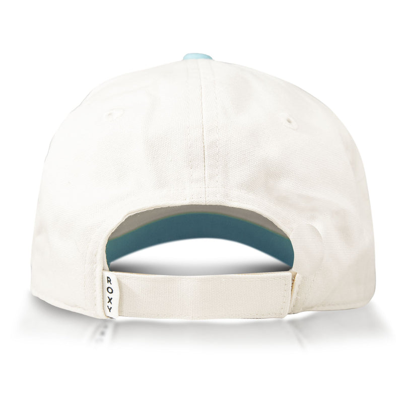 Back view of the Next Level Cap by Roxy—a women’s baseball hat made from soft cotton twill, featuring a curved visor, adjustable strap, and a small Roxy tag on the left side of the strap. The interior is finished in light blue.