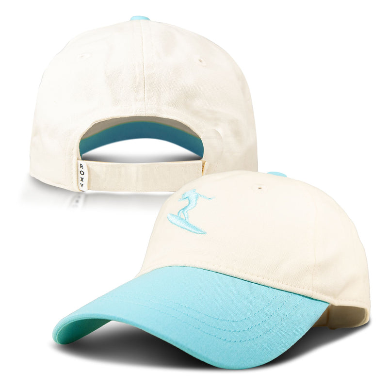The Roxy Next Level Cap is a cream-colored women’s baseball hat crafted from soft cotton twill, featuring a light blue curved visor and an embroidered blue surfer logo on the front. Shown from both the front and back, it includes an adjustable strap with a ROXY label for a comfortable fit.