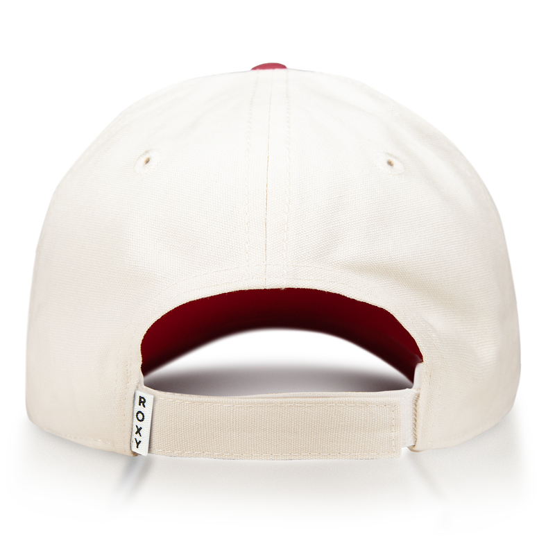 The Roxy Next Level Cap is a cream-colored women’s baseball hat made from soft cotton twill, shown from the back to highlight its adjustable strap with a small white ROXY tag. The inside features a red fabric lining, while the curved visor offers a classic finish.