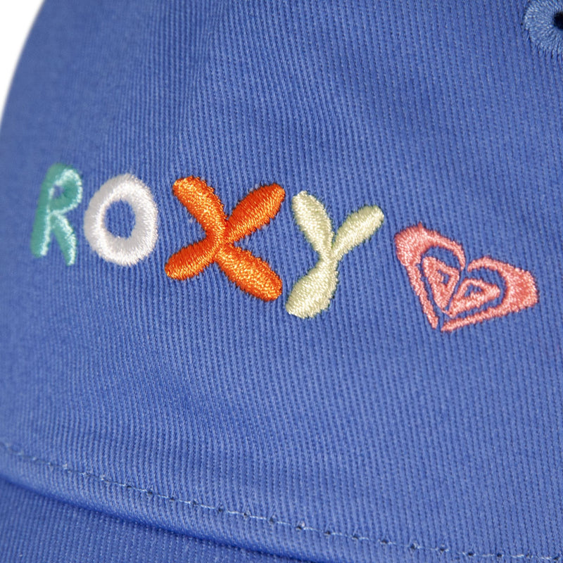 Close-up of blue fabric on the TW Next Level Baseball Cap by Roxy, featuring the word “ROXY” embroidered in colorful thread and a pink heart-shaped logo beside the text, making it a perfect casual accessory.