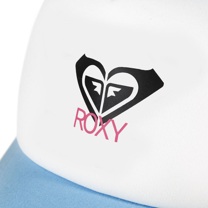 Close-up of the white fabric from the Roxy Donut Spain Trucker hat, showcasing the black heart-shaped Roxy logo above “ROXY” in pink lettering, with a hint of light blue at the bottom—a casually stylish accessory.
