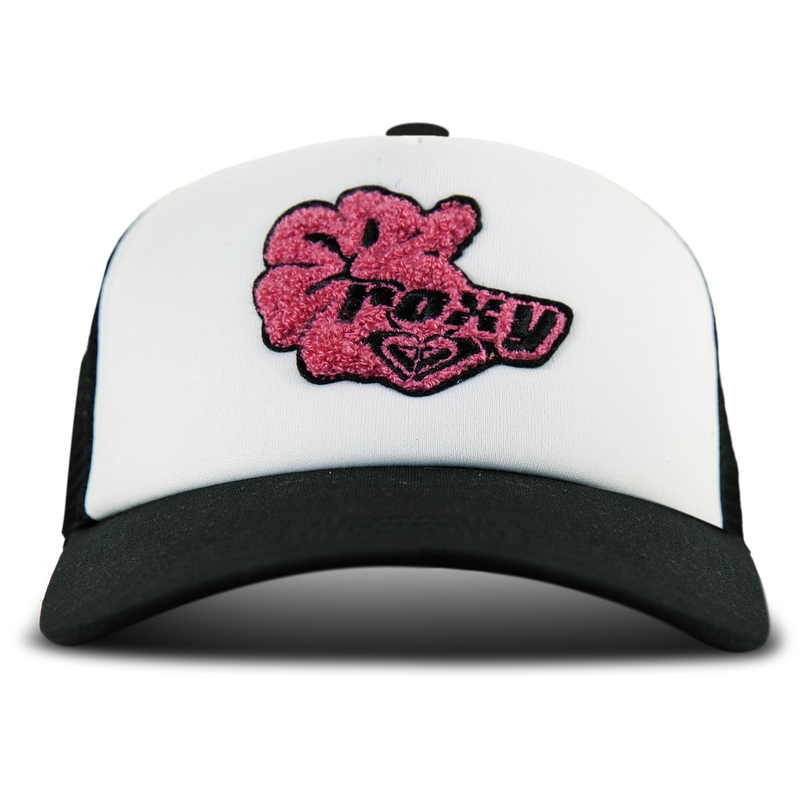 The Roxy Island Ride Trucker hat in Anthracite features a black and white design with pink and black embroidered graphics and text on the front panel, plus an adjustable snapback for a comfortable fit.