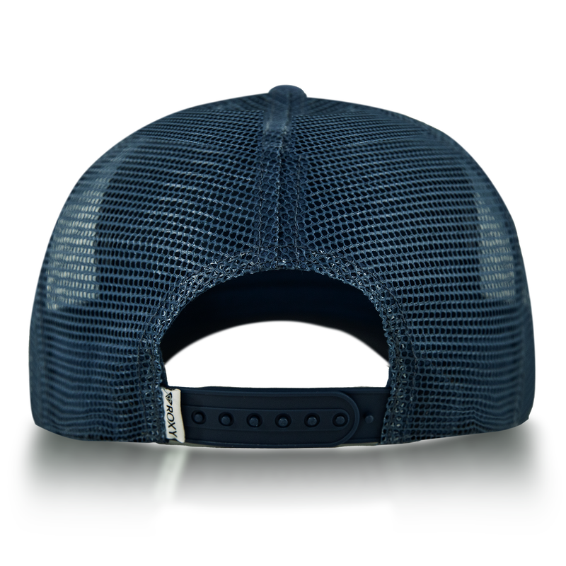 The Roxy Island Ride Trucker hat in navy blue mesh is shown from the back, featuring an adjustable snap closure and a small white tag on the left side.