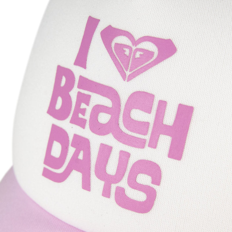 The Roxy Sandy Top Trucker cap features a white crown, a light pink brim, and purple text that says “I ♥ BEACH DAYS”—with the heart designed as a stylized wave complete with two eyes. This hat offers sun protection and includes an adjustable snapback for a customized fit.