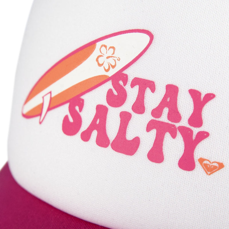 Close-up of the Roxy Sandy Top Trucker cap in white and pink, featuring a graphic surfboard and bold “STAY SALTY” lettering, plus a small heart logo at the bottom right. With an adjustable snapback for the perfect fit, this stylish Roxy cap also provides essential sun protection.