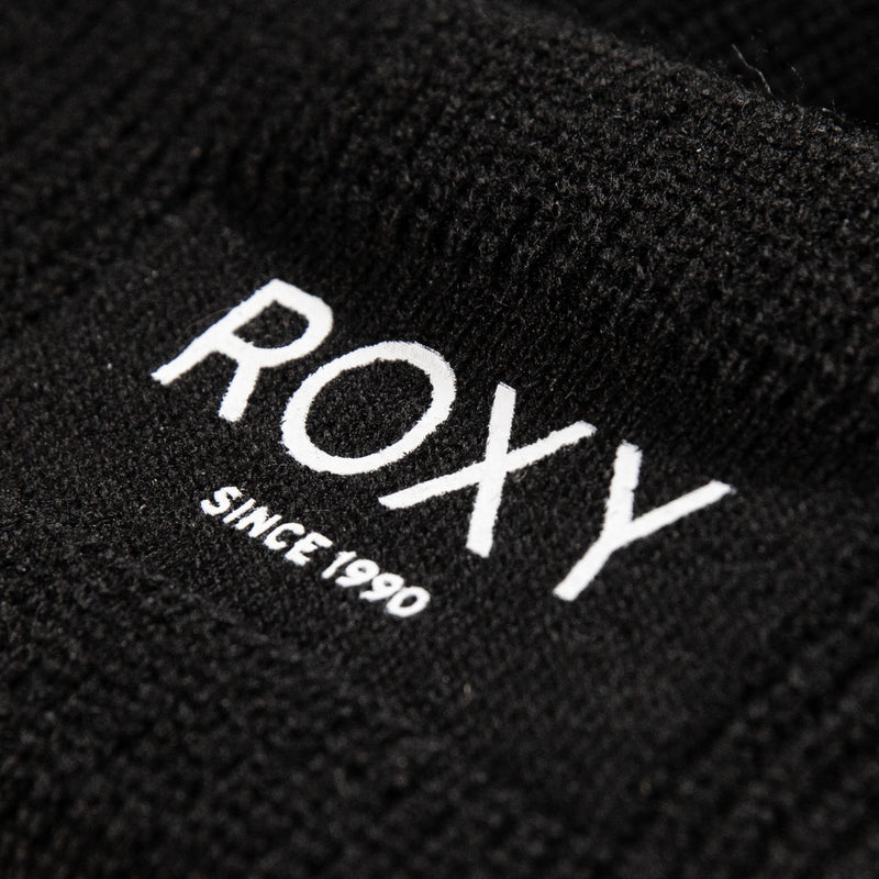 A close-up of a black fabric label displaying the word “ROXY” in white text with “SINCE 1990” written beneath it, featured on the Roxy Blizzard Beanie—a cozy, fleece-lined beanie ideal for cold weather.